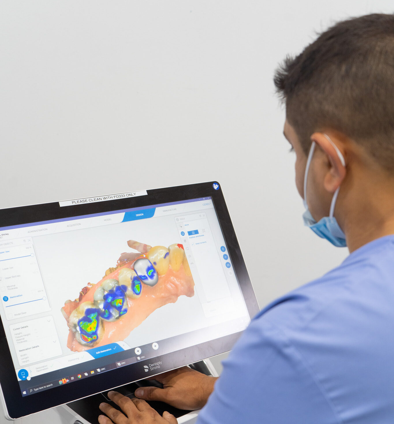 Dr Mitesh 3 Clinician reviews a detailed 3D dental scan on a touchscreen, highlighting how technology enhances precision and patient care in modern dentistry.